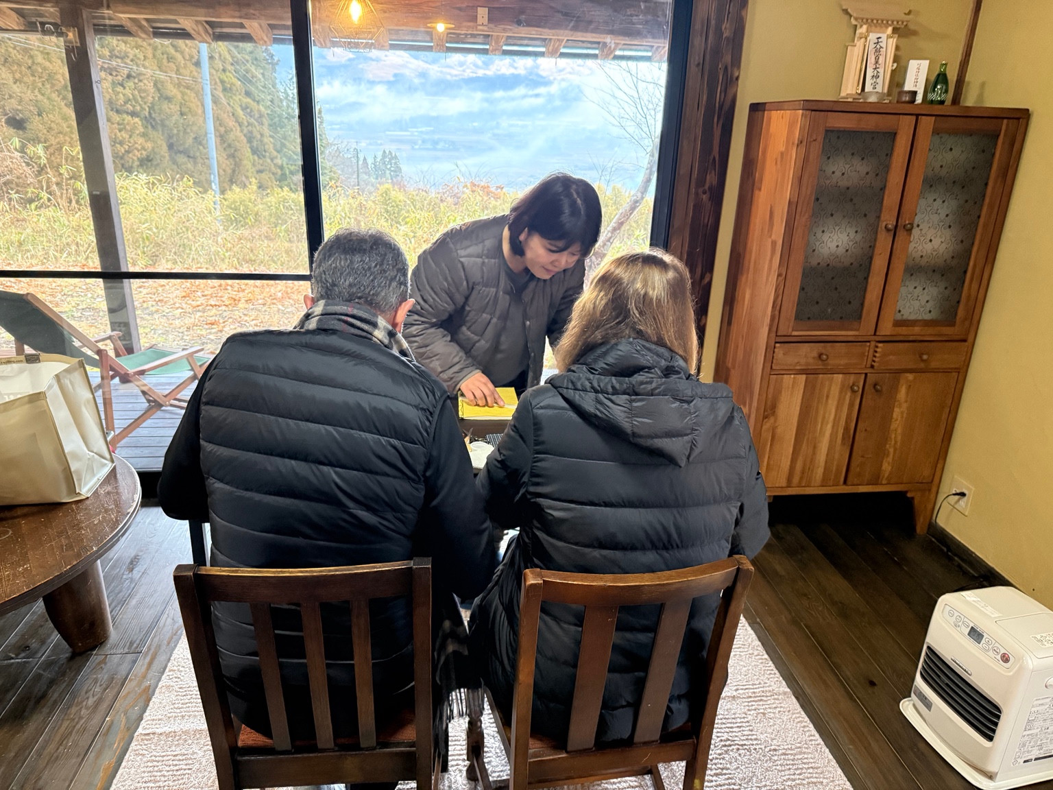 Participants working on notebooks beside a large window overlooking the outdoors